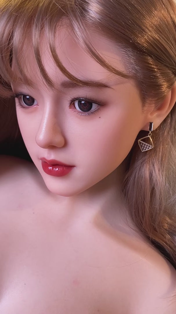 Haiyue, an Asian woman with long hair, full breasts, and a full-body silicone sex doll.