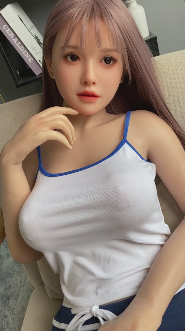 Cailin, an Asian woman with long hair, large breasts, and a full-body silicone sex doll.